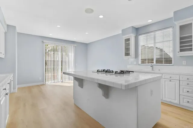 a kitchen with granite countertop a sink and a stove