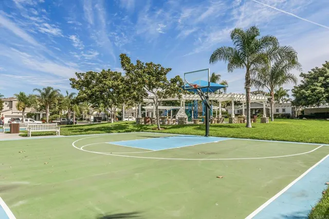 a view of a playground with basketball court