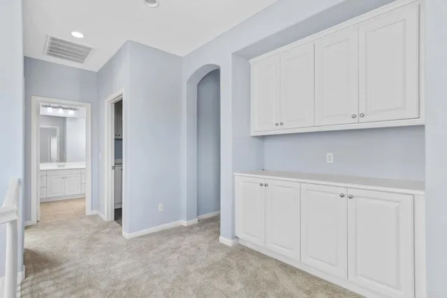 a view of kitchen with white cabinets