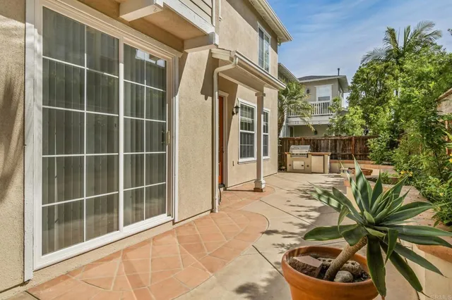 a view of front door and potted plants
