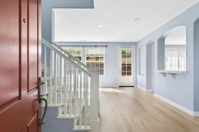 a view of an entryway with wooden floor