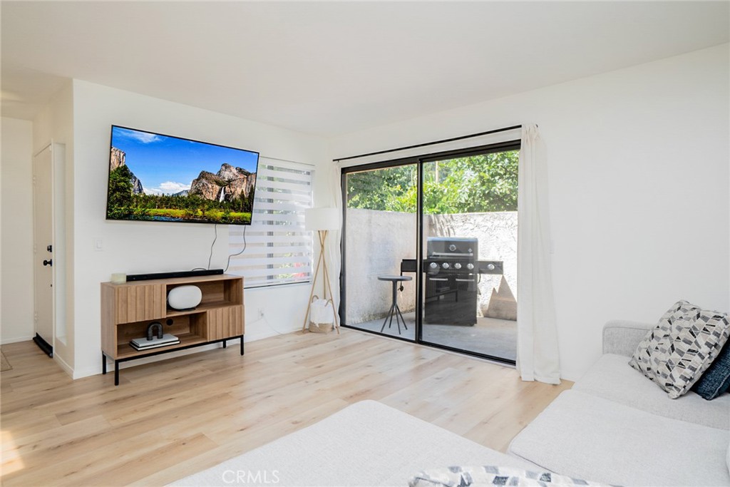 8025 70th Street Paramount, CA 90723 - Photo 1 of 31 a living room with furniture a fireplace and a flat screen tv