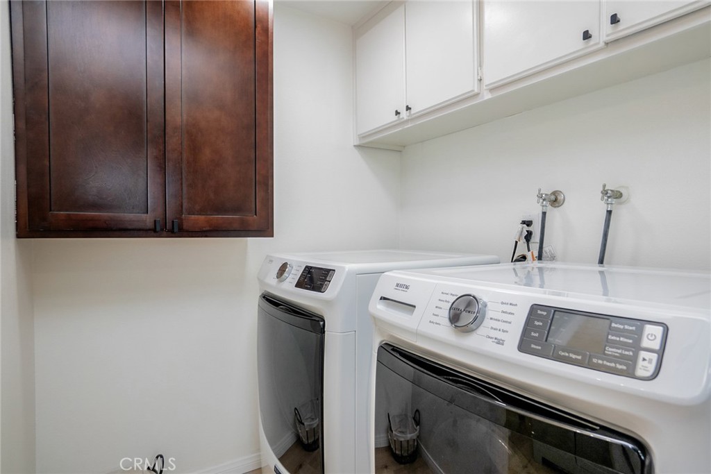8025 70th Street Paramount, CA 90723 - Photo 13 of 31 a utility room with dryer and washer