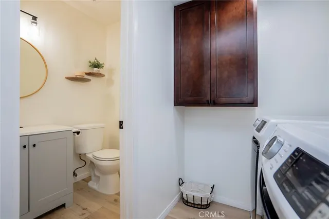 a bathroom with a sink a mirror and toilet