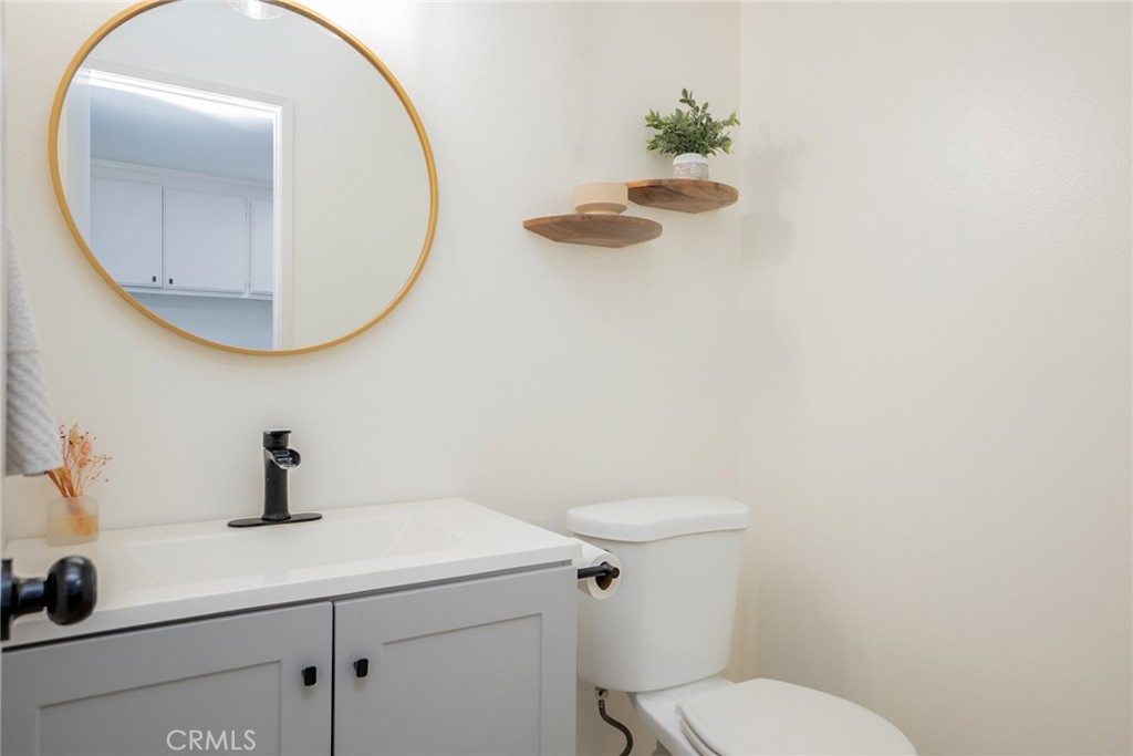 8025 70th Street Paramount, CA 90723 - Photo 15 of 31 a bathroom with a sink a mirror and toilet
