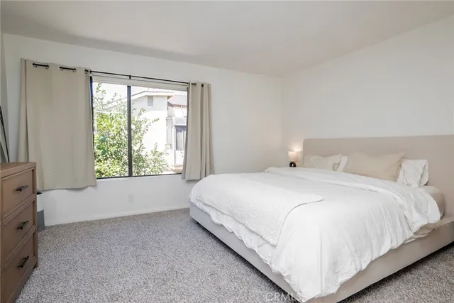 a bedroom with a bed and a dresser