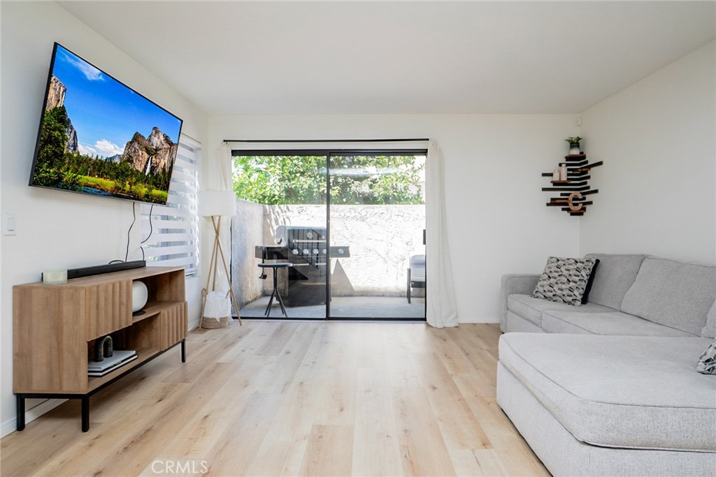 8025 70th Street Paramount, CA 90723 - Photo 2 of 31 a living room with furniture and a flat screen tv