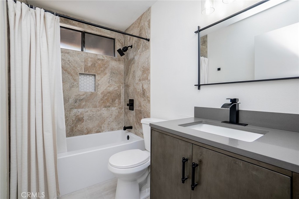8025 70th Street Paramount, CA 90723 - Photo 22 of 31 a bathroom with a sink a toilet and shower