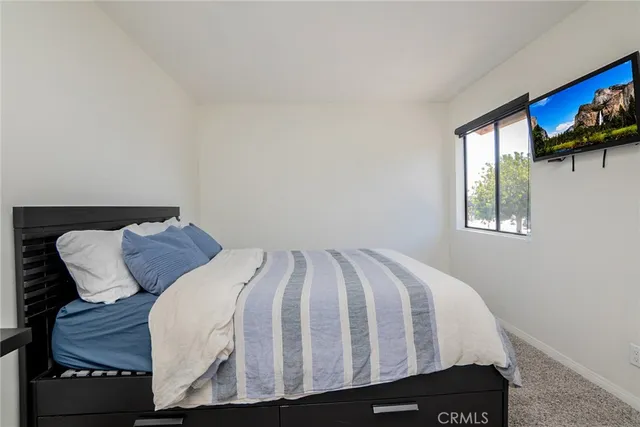 a bedroom with a bed and a shower