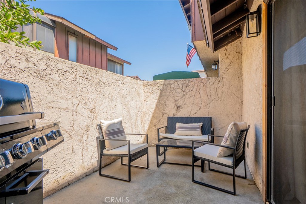8025 70th Street Paramount, CA 90723 - Photo 25 of 31 a backyard of a house with fire pit and chairs