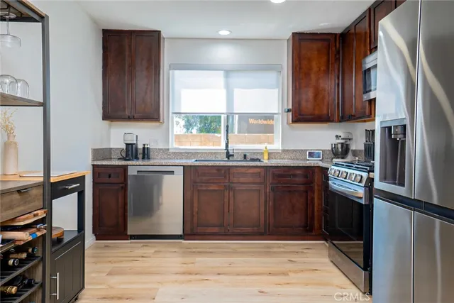 a kitchen with stainless steel appliances granite countertop a refrigerator sink and cabinets