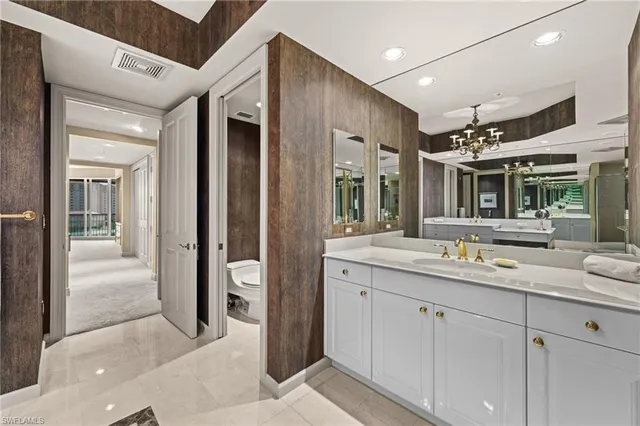 a spacious bathroom with a granite countertop sink mirror and toilet
