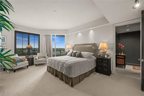 a bedroom with a bed and a couch