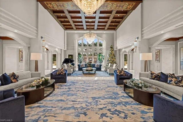 a large room with lots of furniture and chandelier