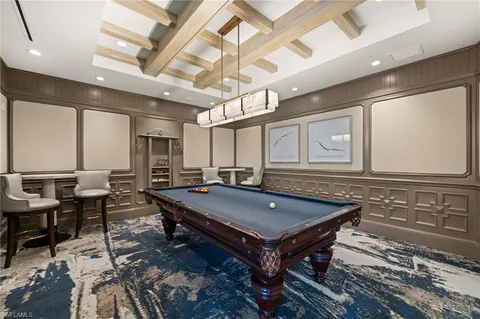 a room with furniture pool table and windows