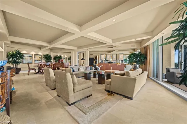 a living room with fireplace furniture and a large window