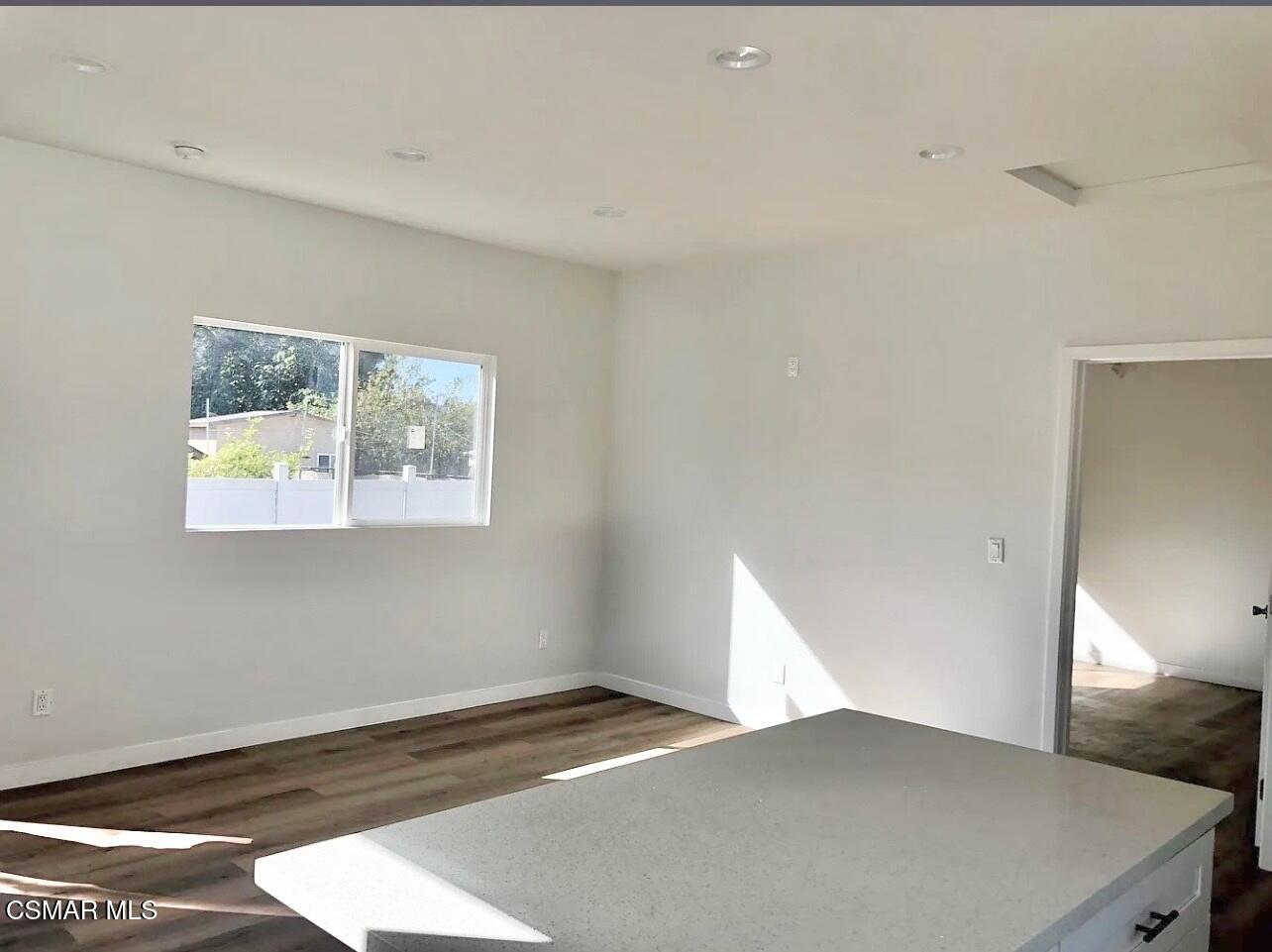 14083 La Rue Street San Fernando, CA 91340 - Photo 2 of 5 a view of an empty room with wooden floor and a window