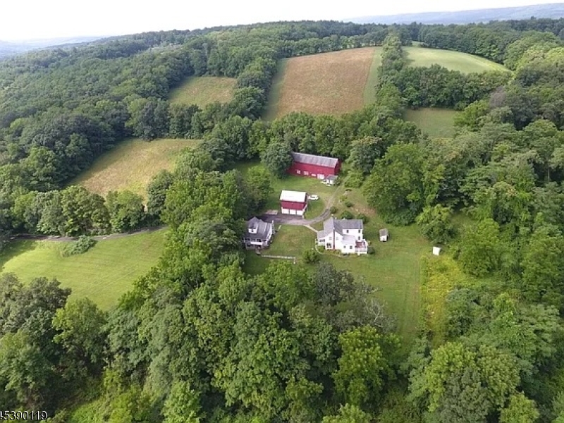 a aerial view of residential house with outdoor space and trees around