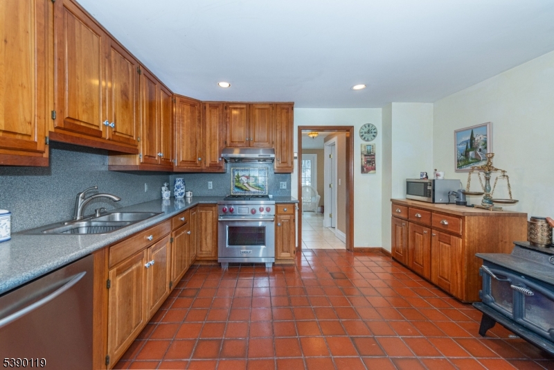107 Clove Road, Unit 3 Wantage, NJ 07461 - Photo 13 of 45 a kitchen with stainless steel appliances granite countertop a stove a sink dishwasher and a refrigerator with cabinets