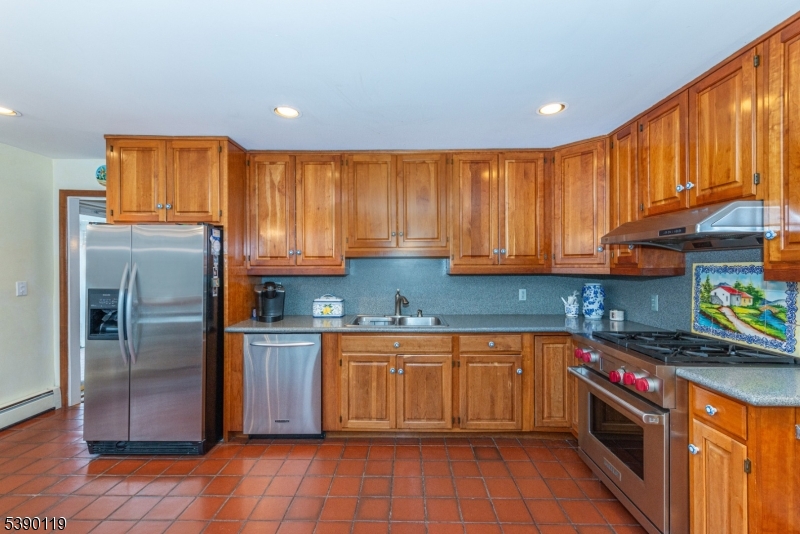 107 Clove Road, Unit 3 Wantage, NJ 07461 - Photo 15 of 45 a kitchen with stainless steel appliances granite countertop a stove a sink dishwasher and a refrigerator