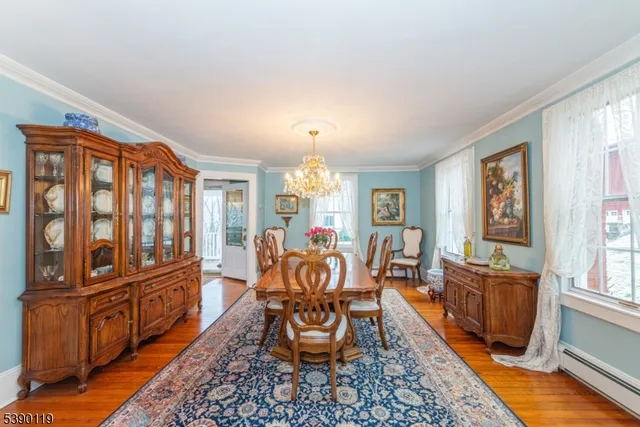 a living room with furniture a dining table and chairs with wooden floor