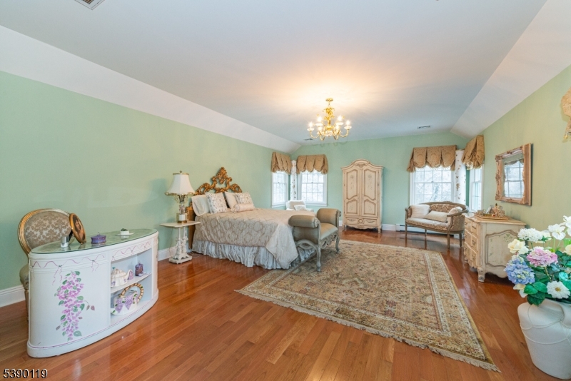 107 Clove Road, Unit 3 Wantage, NJ 07461 - Photo 19 of 45 a bedroom with furniture and a chandelier