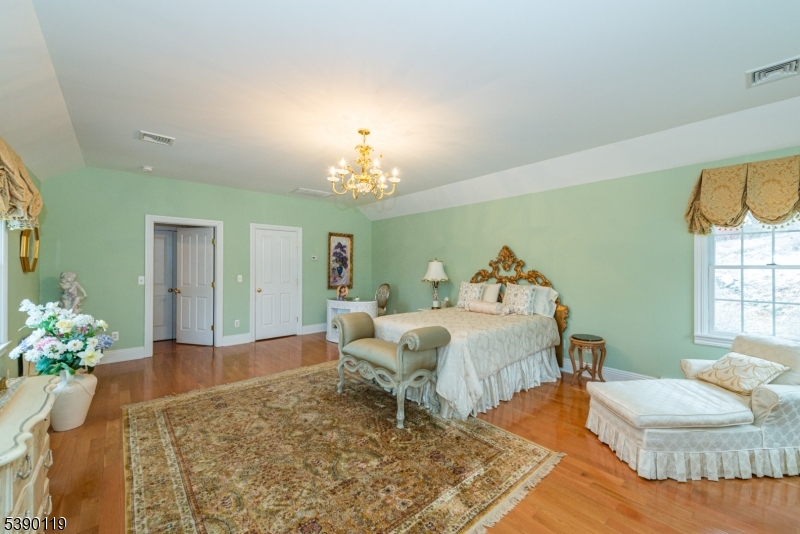 107 Clove Road, Unit 3 Wantage, NJ 07461 - Photo 20 of 45 a living room with furniture and a chandelier