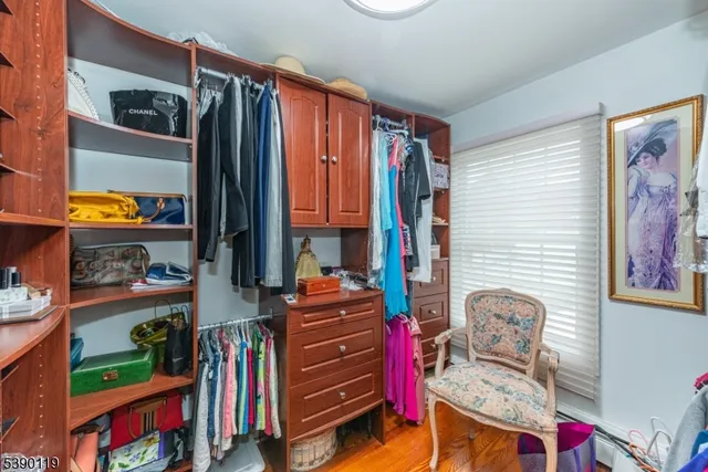a view of walk in closet with clothes and shoes