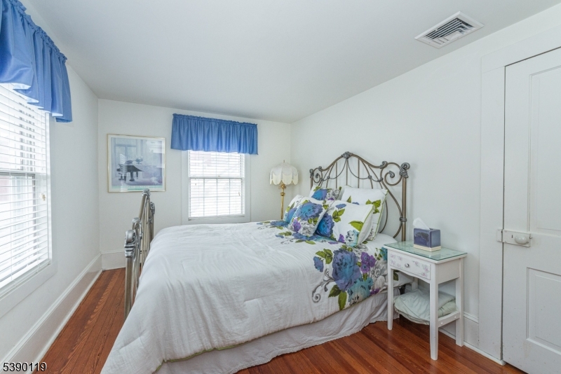 107 Clove Road, Unit 3 Wantage, NJ 07461 - Photo 23 of 45 a bedroom with a bed and wooden floor