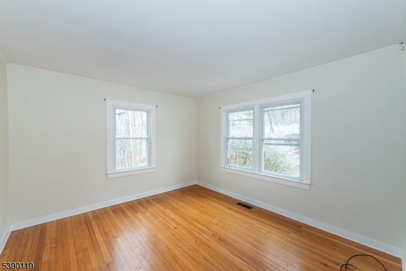 107 Clove Road, Unit 3 Wantage, NJ 07461 - Photo 30 of 45 a view of an empty room with wooden floor and a window