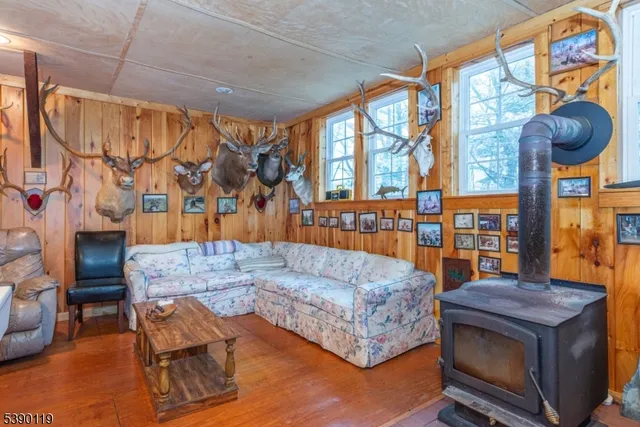 a living room with fireplace furniture and a large window