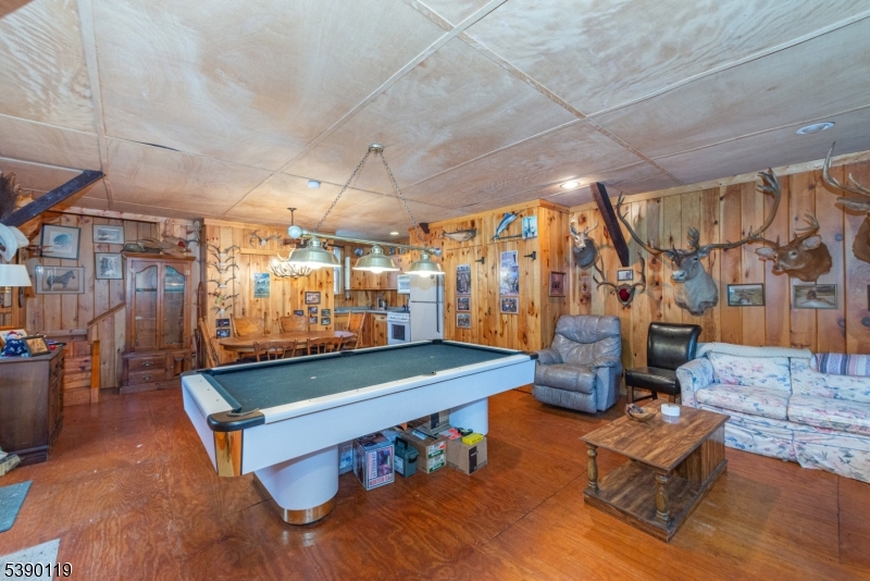 107 Clove Road, Unit 3 Wantage, NJ 07461 - Photo 39 of 45 a room with lots of furniture and a chandelier