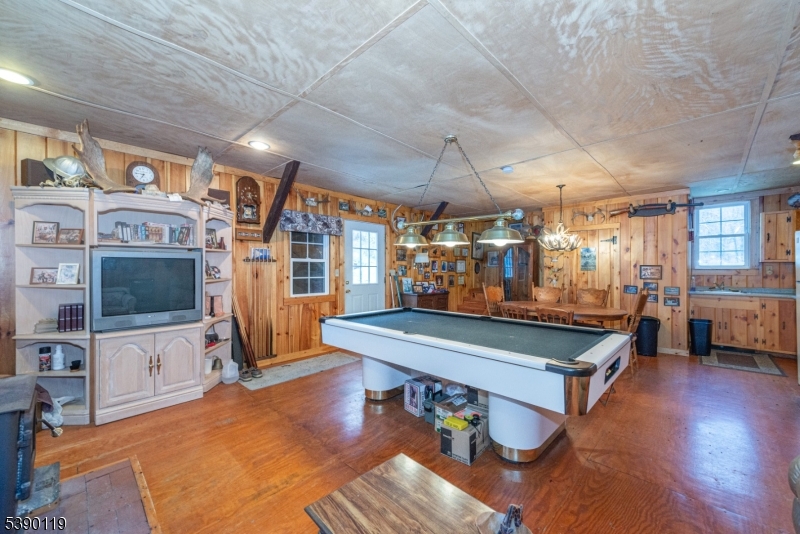 107 Clove Road, Unit 3 Wantage, NJ 07461 - Photo 40 of 45 a living room with furniture a flat screen tv and a table