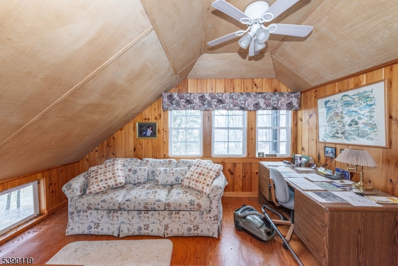 107 Clove Road, Unit 3 Wantage, NJ 07461 - Photo 43 of 45 a living room with furniture a chandelier and a large window