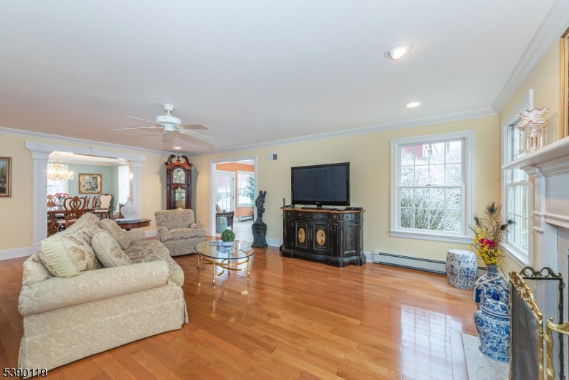 107 Clove Road, Unit 3 Wantage, NJ 07461 - Photo 8 of 45 a living room with furniture a flat screen tv and a fireplace