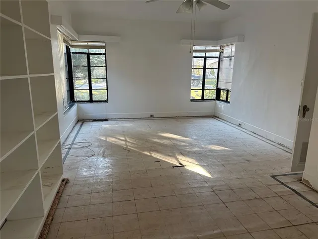 an empty room with windows and entrance