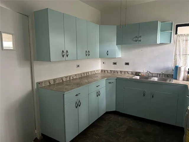 a room with cabinets and washer