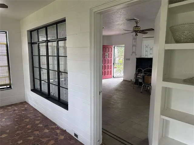 a view of a livingroom with a fireplace and a window
