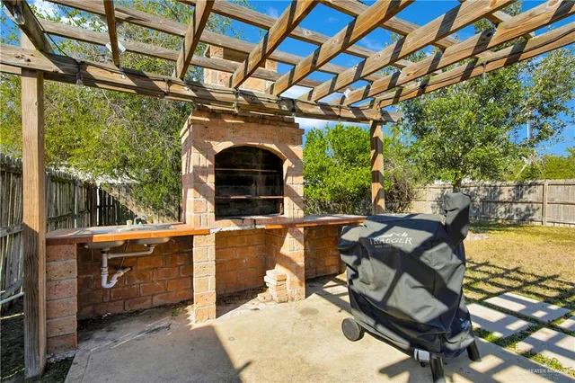 a roof deck with table and chairs and potted plants