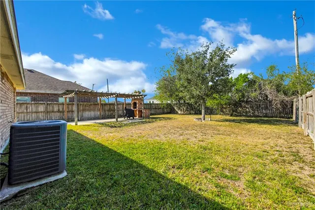 a view of a swimming pool with an outdoor seating and a yard