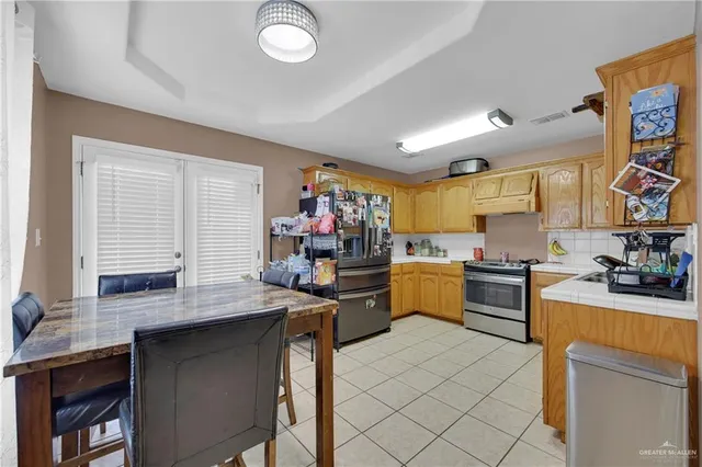 a kitchen with a sink stove and cabinets