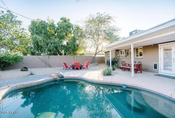 swimming pool view with a outdoor seating