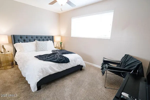 a bedroom with a bed and dresser