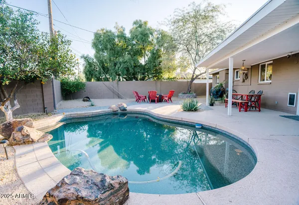 a view of a swimming pool with a patio