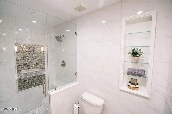 a bathroom with a bathtub shower sink and toilet