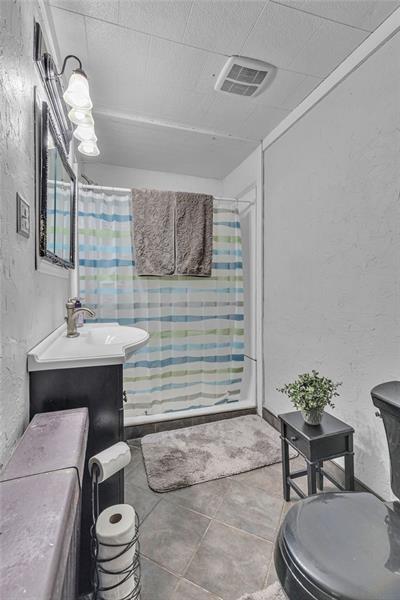 3159 Brodhead Road Aliquippa, PA 15001 - Photo 15 of 30 a bathroom with a toilet a sink and mirror