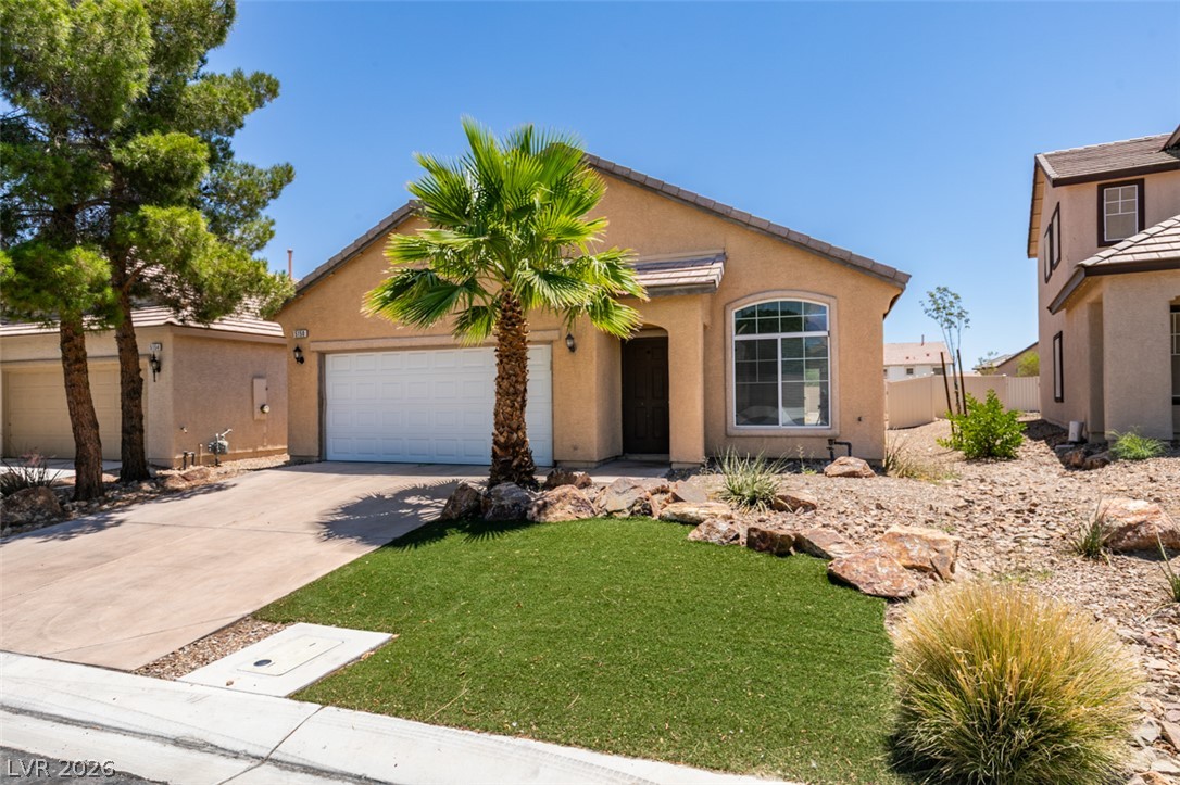 5150 Riverside Run Court North Las Vegas, NV 89081 - Photo 2 of 50 A desert-friendly landscape with a lush patch of green artificial turf invites you home.