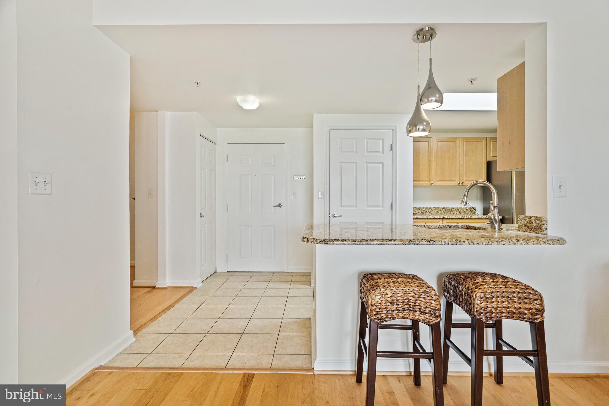 2726 Gallows Road, Unit 712 Vienna, VA 22180 - Photo 7 of 55 a view of a dining room with furniture and chandelier