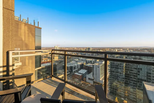a view of a balcony with chair and ocean view