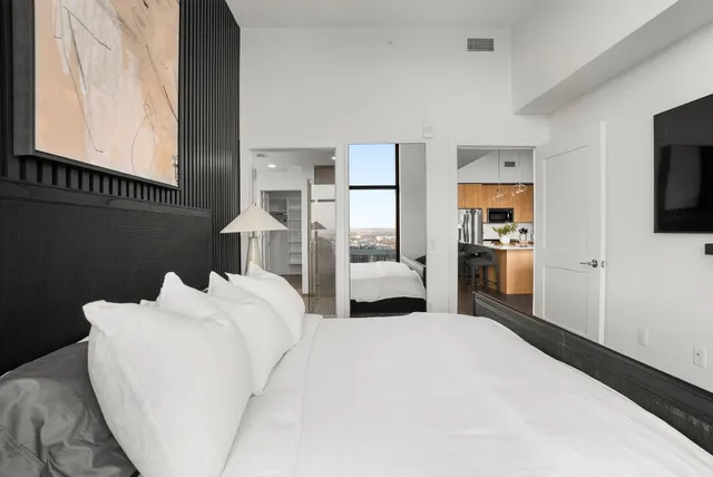 a bedroom with a bed and a television